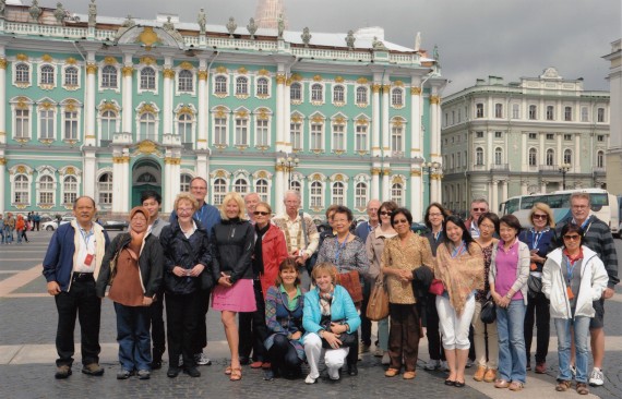 Lina Briones and Susie Carpena (6th and 7th from the left, front row standing; the young lady next to Susie is also from the Philippines) at the Palace Square, St. Petersburg, Russia (the building behind them is the Winter Palace)